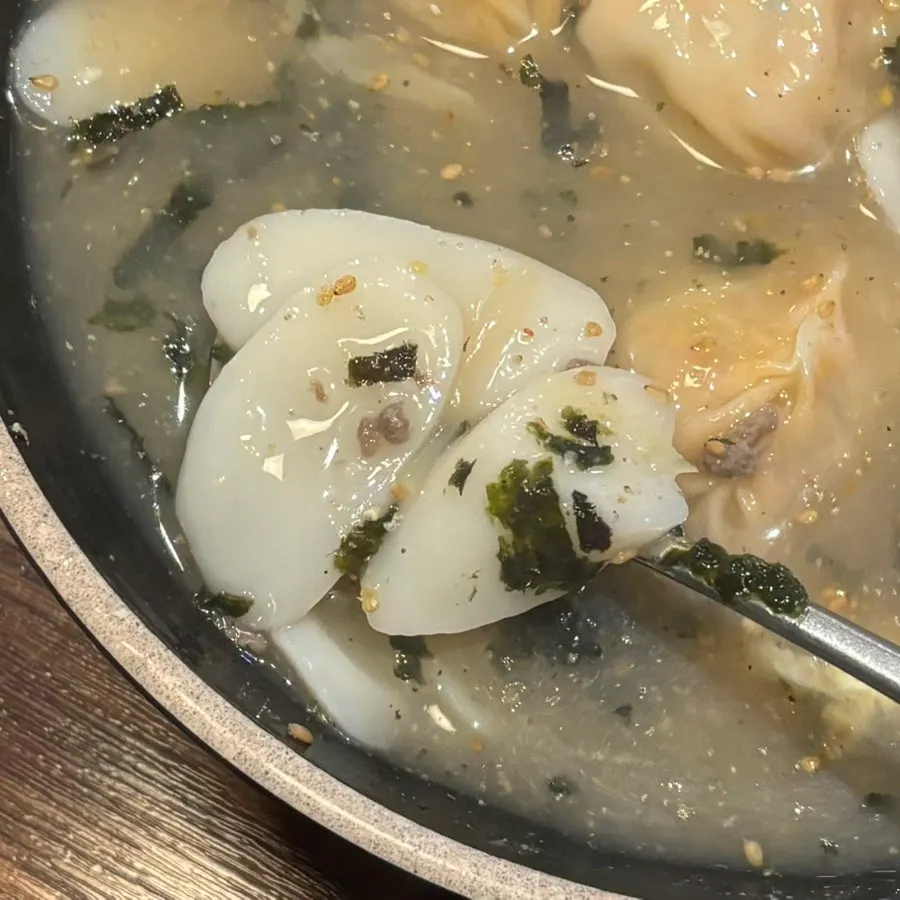 Close-up of the tteok-mandu-guk broth and ingredients