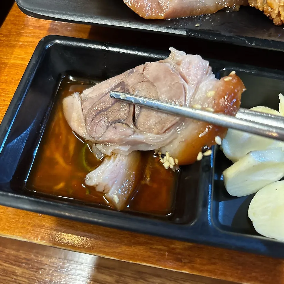 A piece of jokbal dipped in salted shrimp