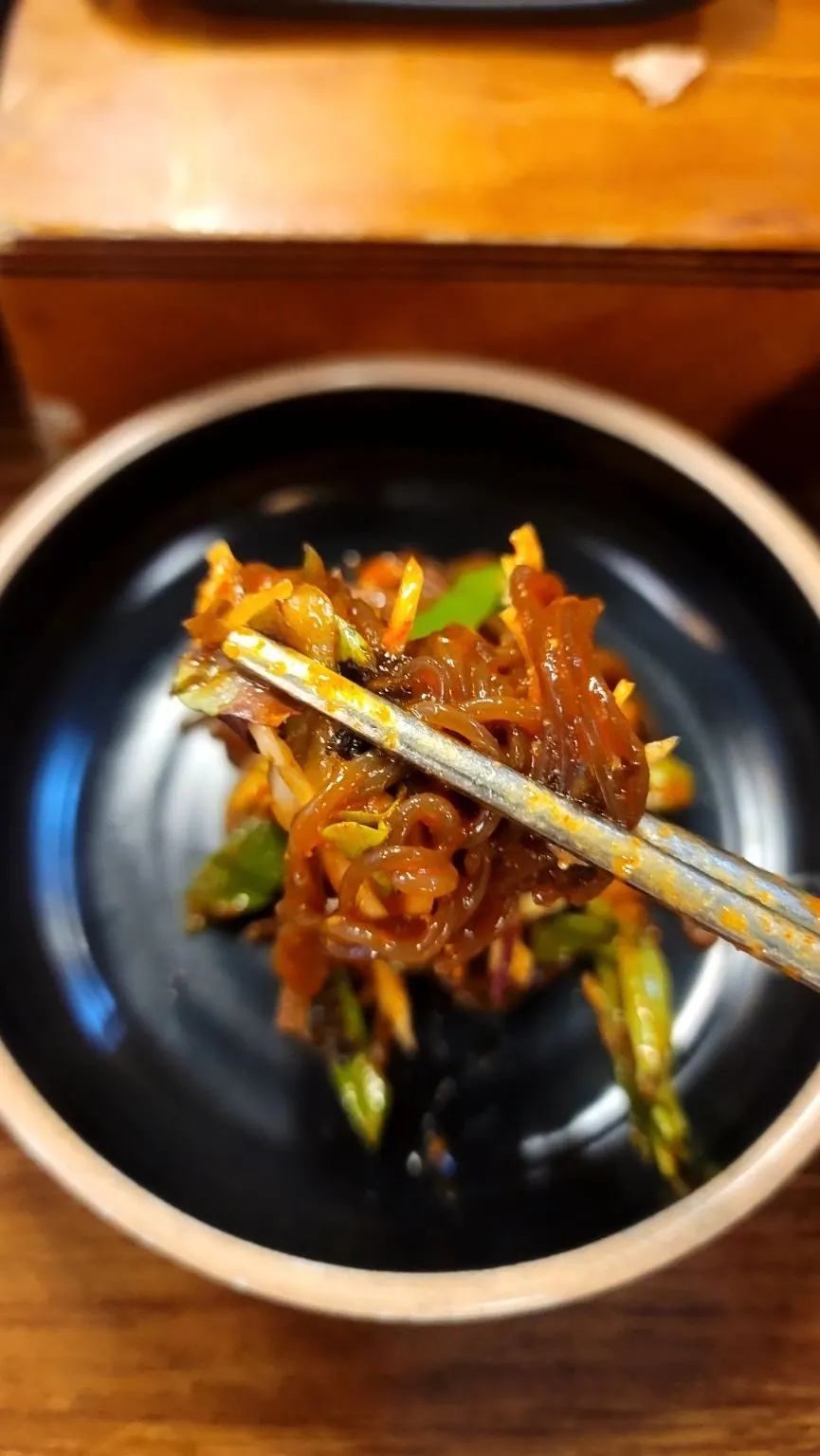 Makguksu noodles topped with a generous helping of vegetables
