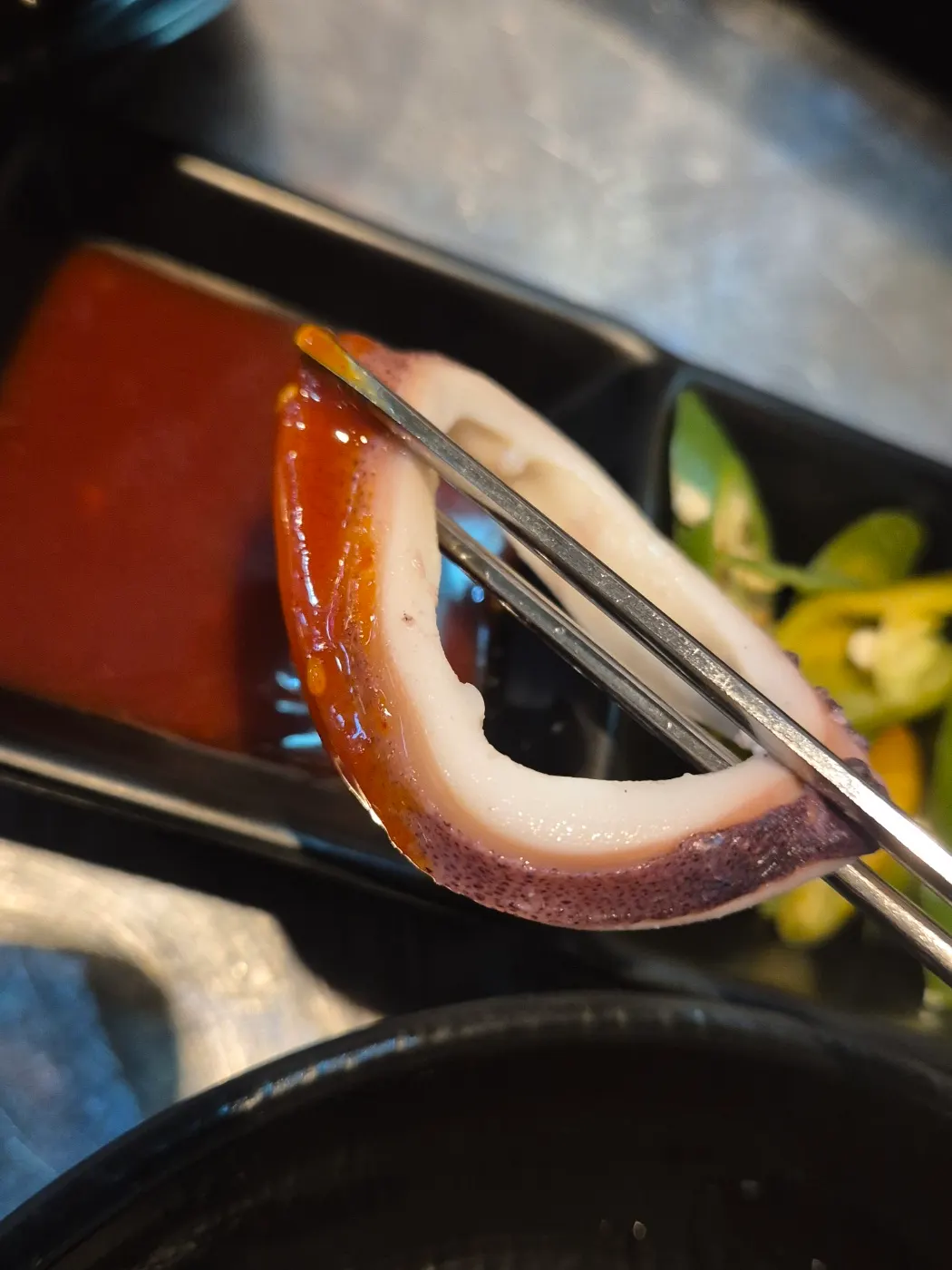 Dipping the boiled squid into chojang