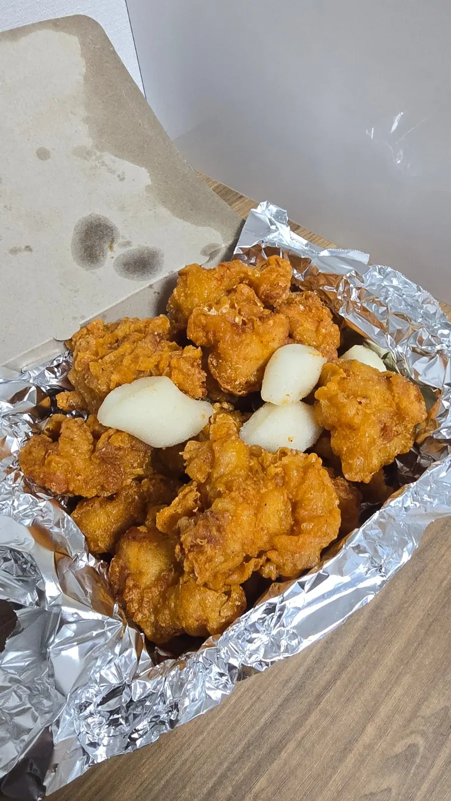 Medium fried dakgangjeong in a takeout container