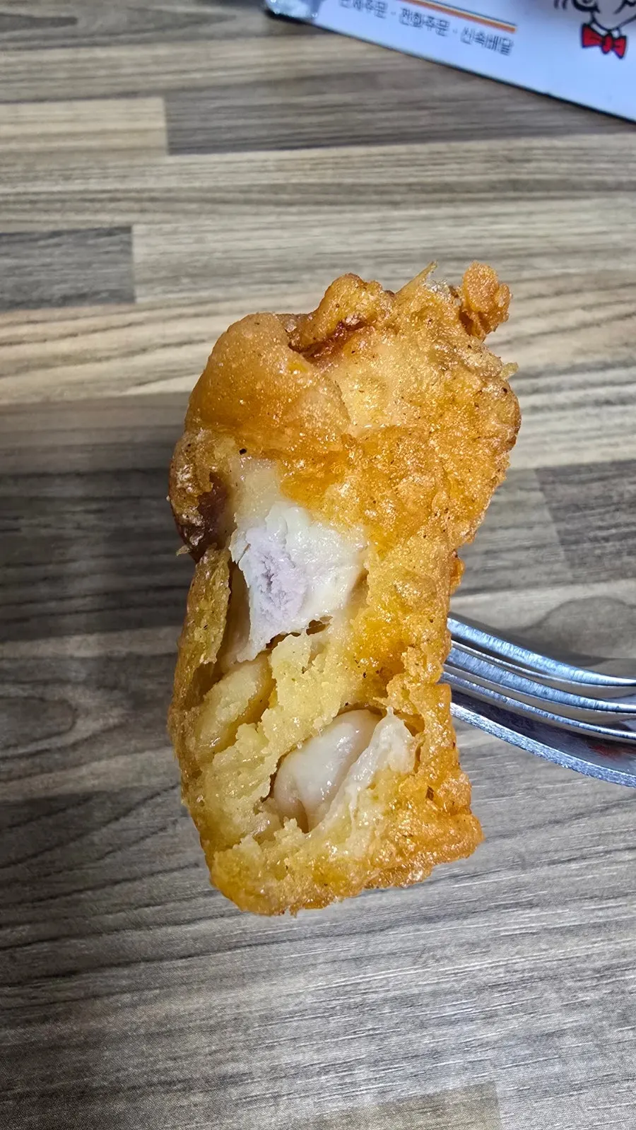 Dakgangjeong showing savory chicken meat inside