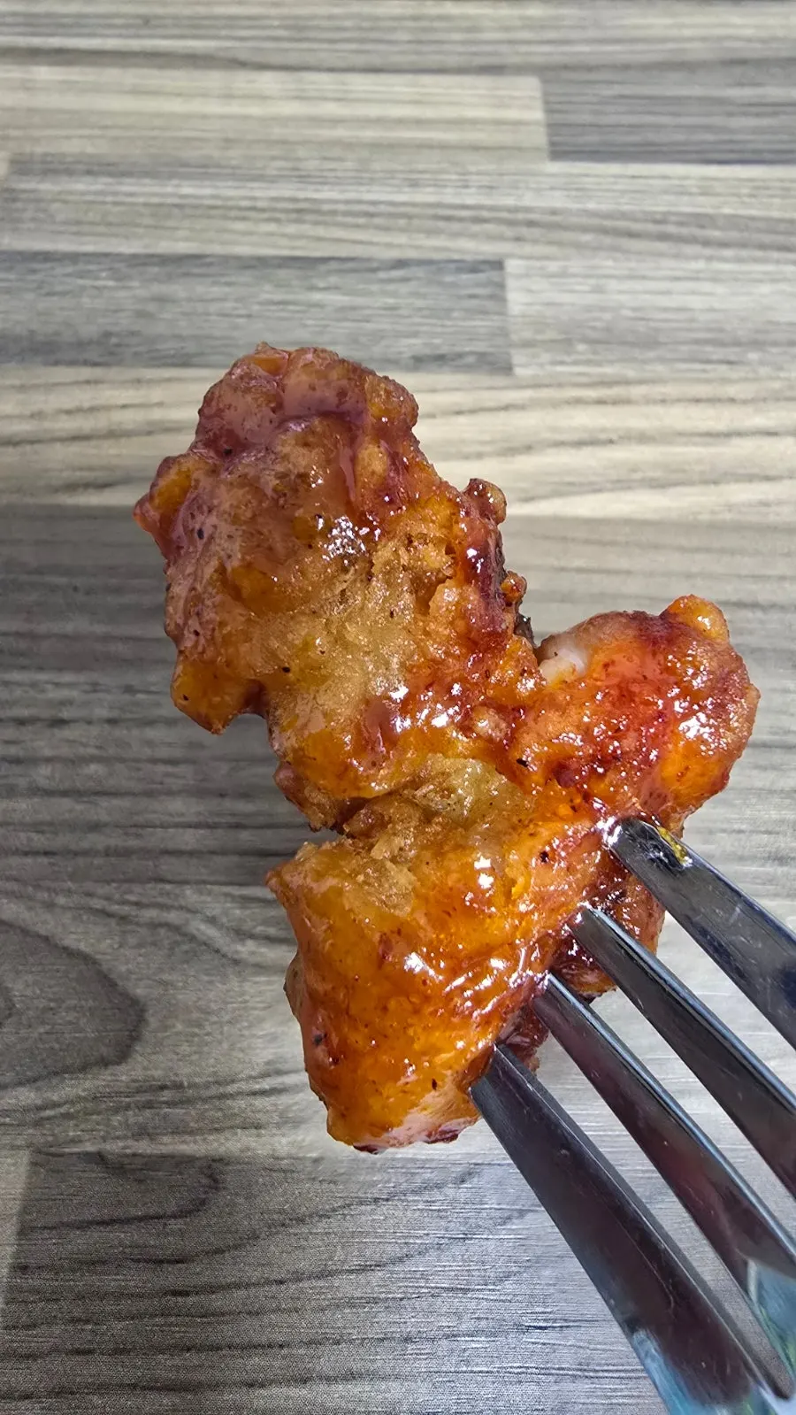 Seasoned dakgangjeong on a skewer
