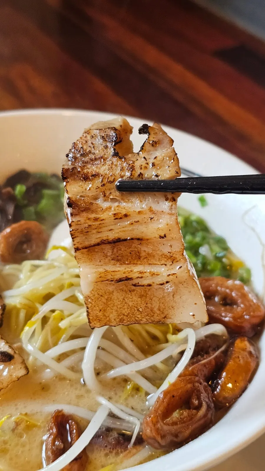 Scooping up the rich ramen broth