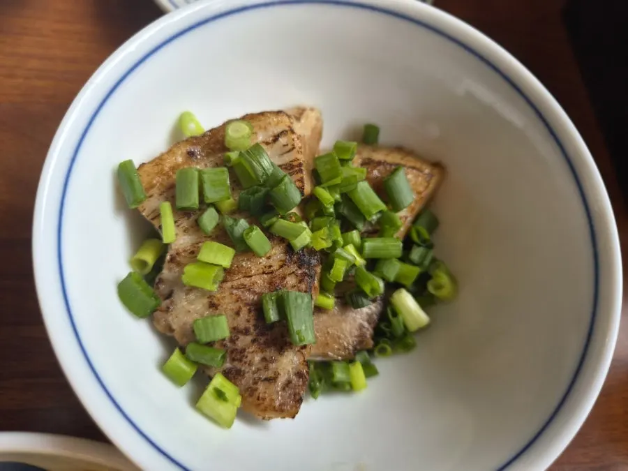 Tender chashu lifted with chopsticks