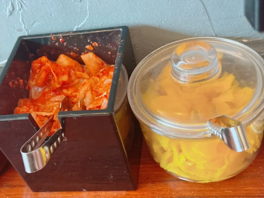 Kimchi and danmuji portioned out on the table