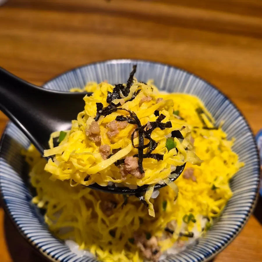 Tamagobap topped with egg omelet strips and pork