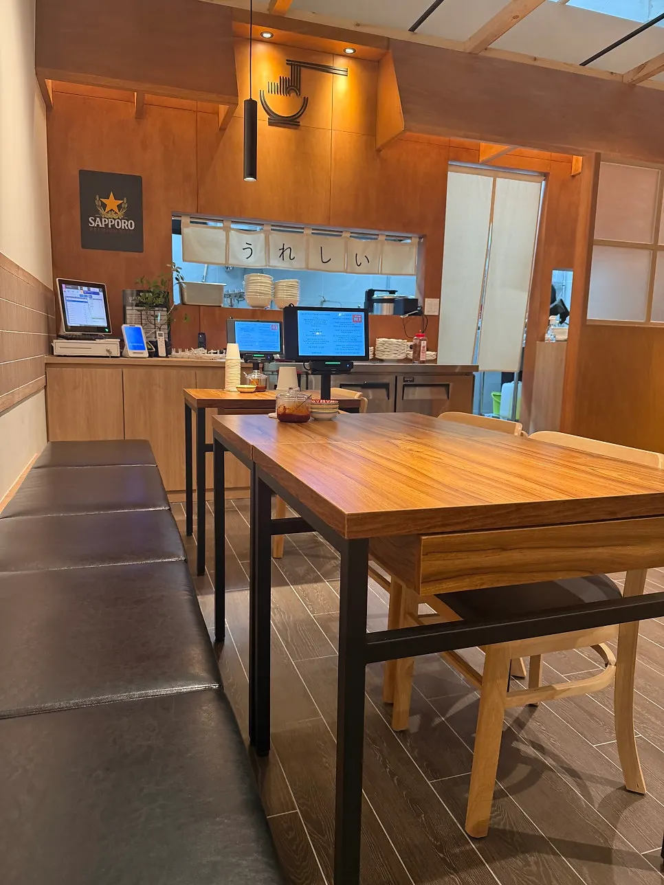 Seating area with wood-toned interior and warm lighting at the ramen shop