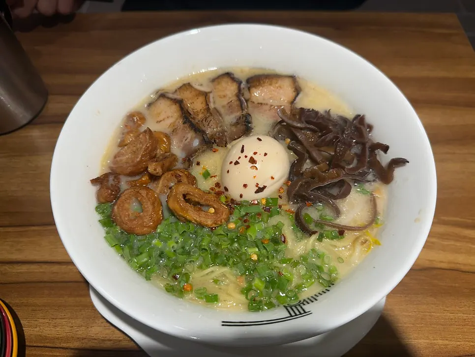 Close-up of motsu ramen topped with grilled tripe
