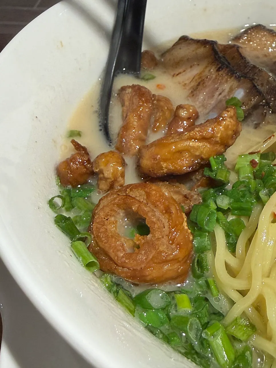 Motsu ramen piled high with toppings after adding extra grilled tripe