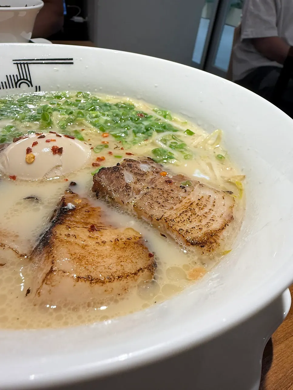 Ramen bowl with most of the noodles and toppings eaten