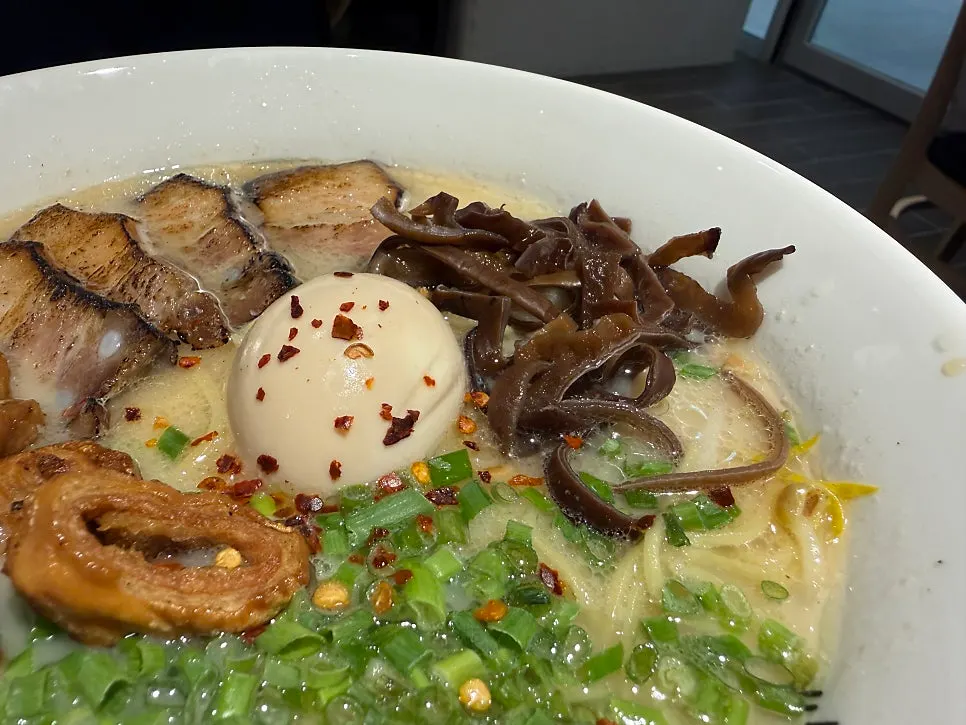 Close-up shot of motsu ramen with grilled tripe in rich broth