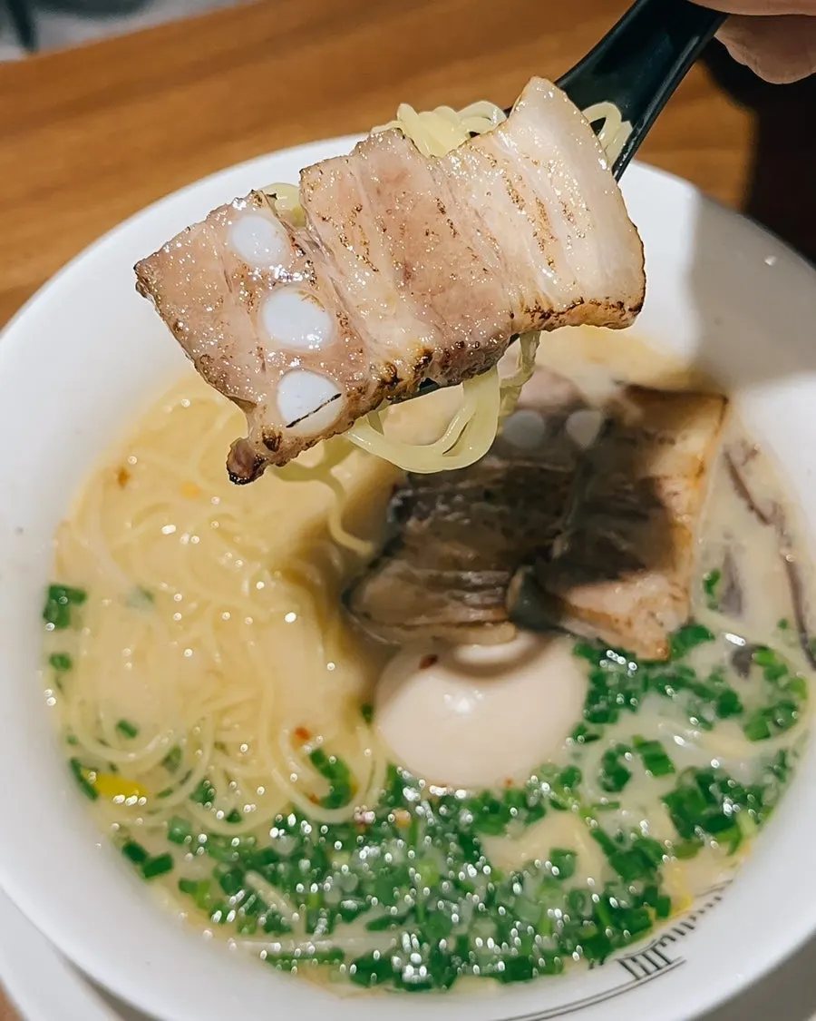 Thin straight noodles lifted from the bowl