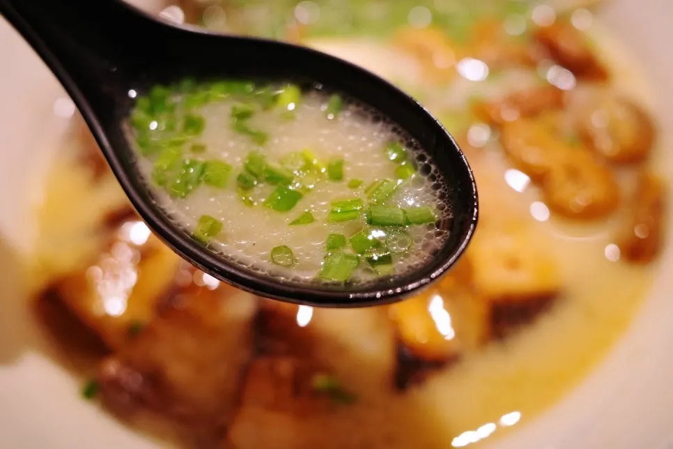 A bowl of Gyedan Ramen Jinham topped with chashu and pork intestine