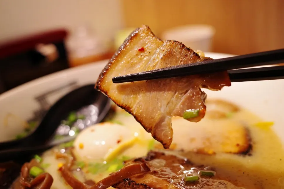 Close-up of pork intestine topping soaked in broth