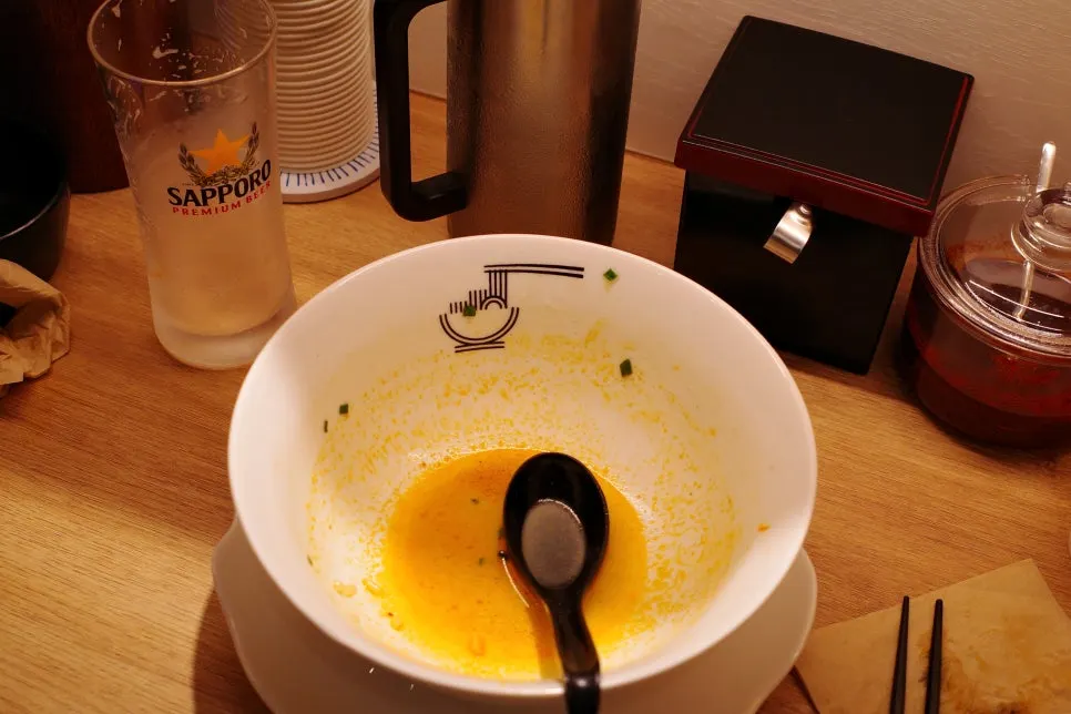 A spoonful of rice mixed into the broth