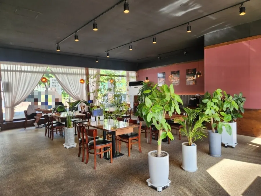 Table seating at Gyeomson Donkatsu Geomdan Branch with antique wallpaper and curtains