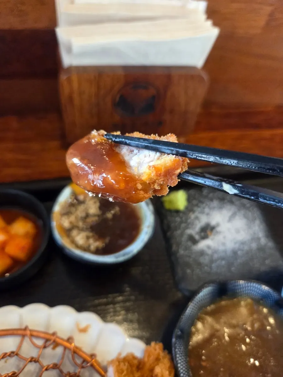 Meat dipped in curry sauce and pork cutlet sauce