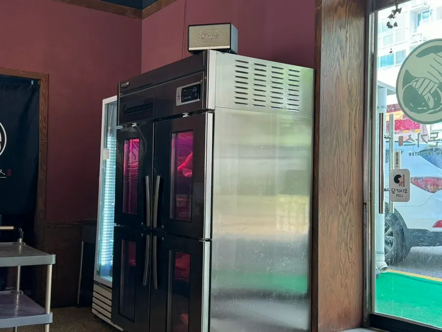 Meat aging fridge on one side of the restaurant
