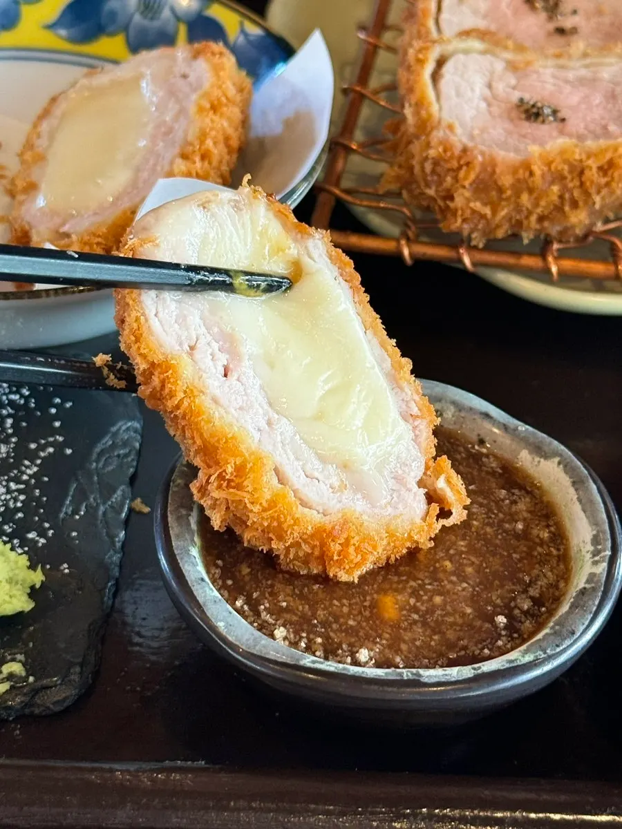 Cross-section of the crispy-outside, gooey-inside cheese katsu