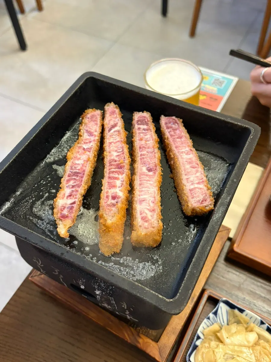 A piece of sirloin gyukatsu grilling on the mini brazier