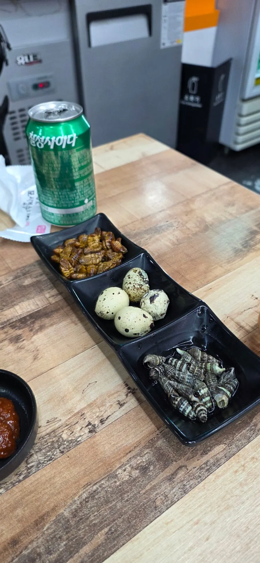 Side dishes of beondegi, quail eggs and whelk