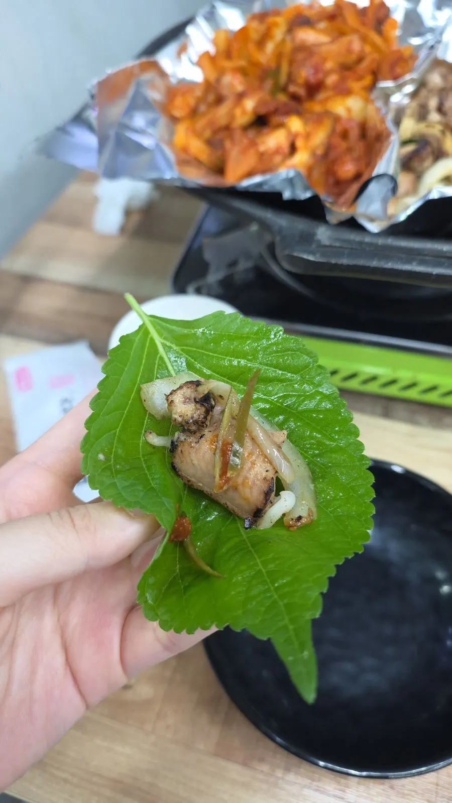 Salt-grilled kkomjangeo wrapped in a perilla leaf