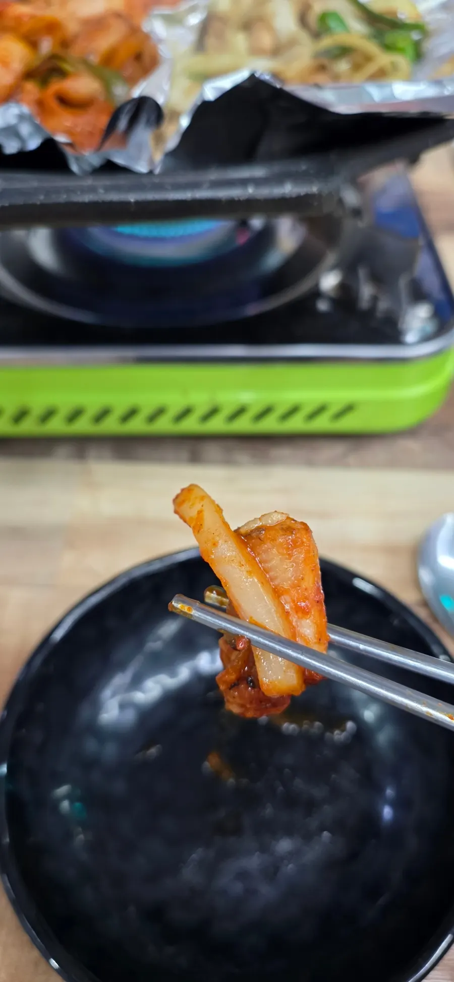 Sauced kkomjangeo turning red as it cooks