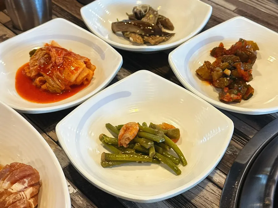 Table set with seasoned pork ribs and side dishes