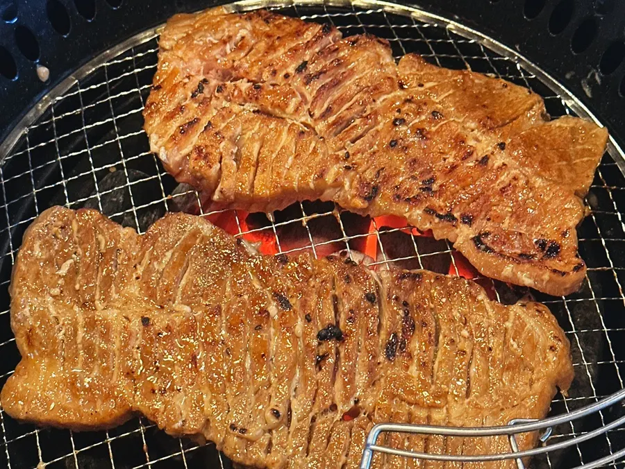 A piece of seasoned ribs lightly dipped in sauce