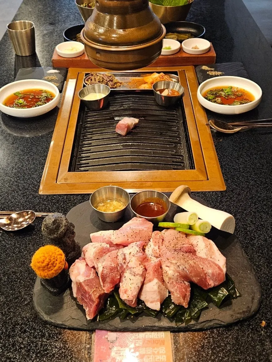 Black pork fat and meat placed on the grill plate