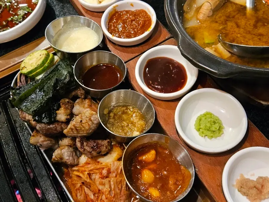 Four sauces simmering on the grill plate