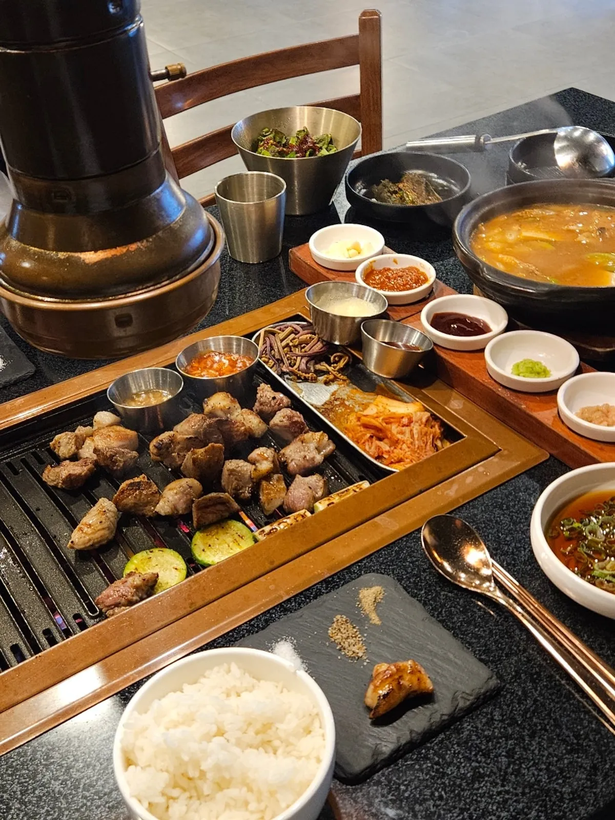 Grilled black pork and side dishes on the grill plate