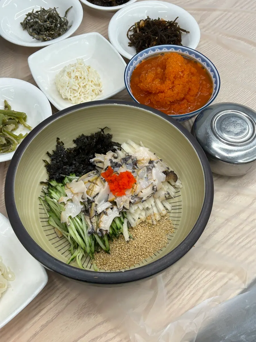 A table spread with abalone mulhoe and abalone porridge