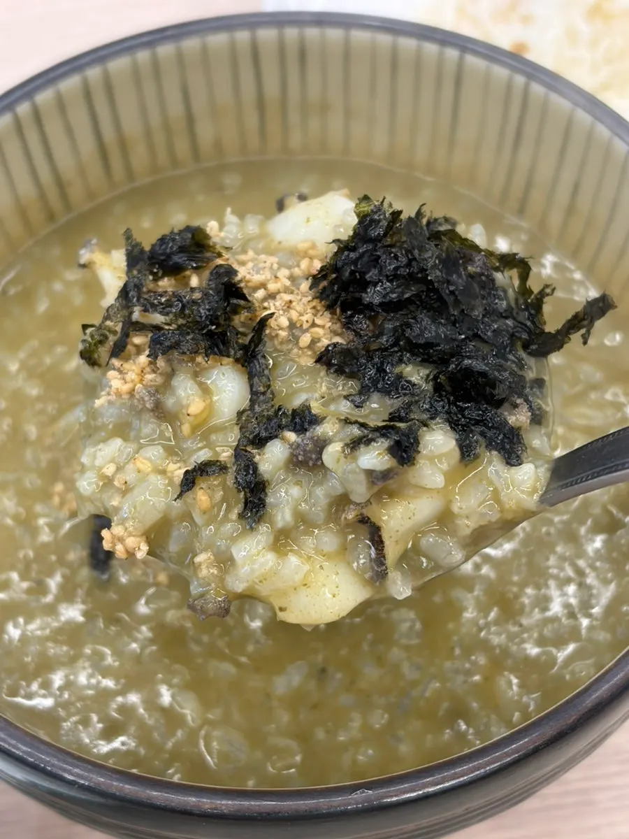A generously portioned bowl of abalone porridge on the table