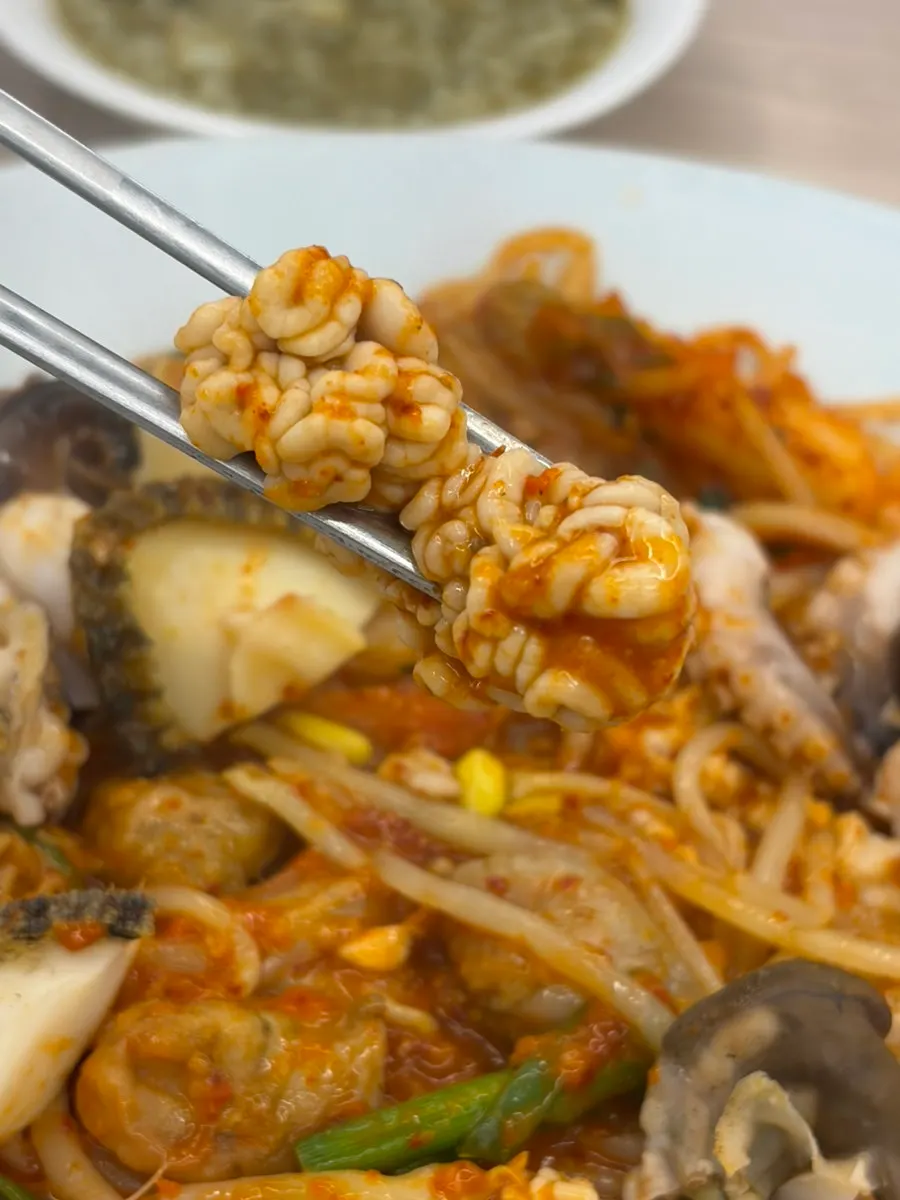 A piece of abalone coated in the stew's sauce