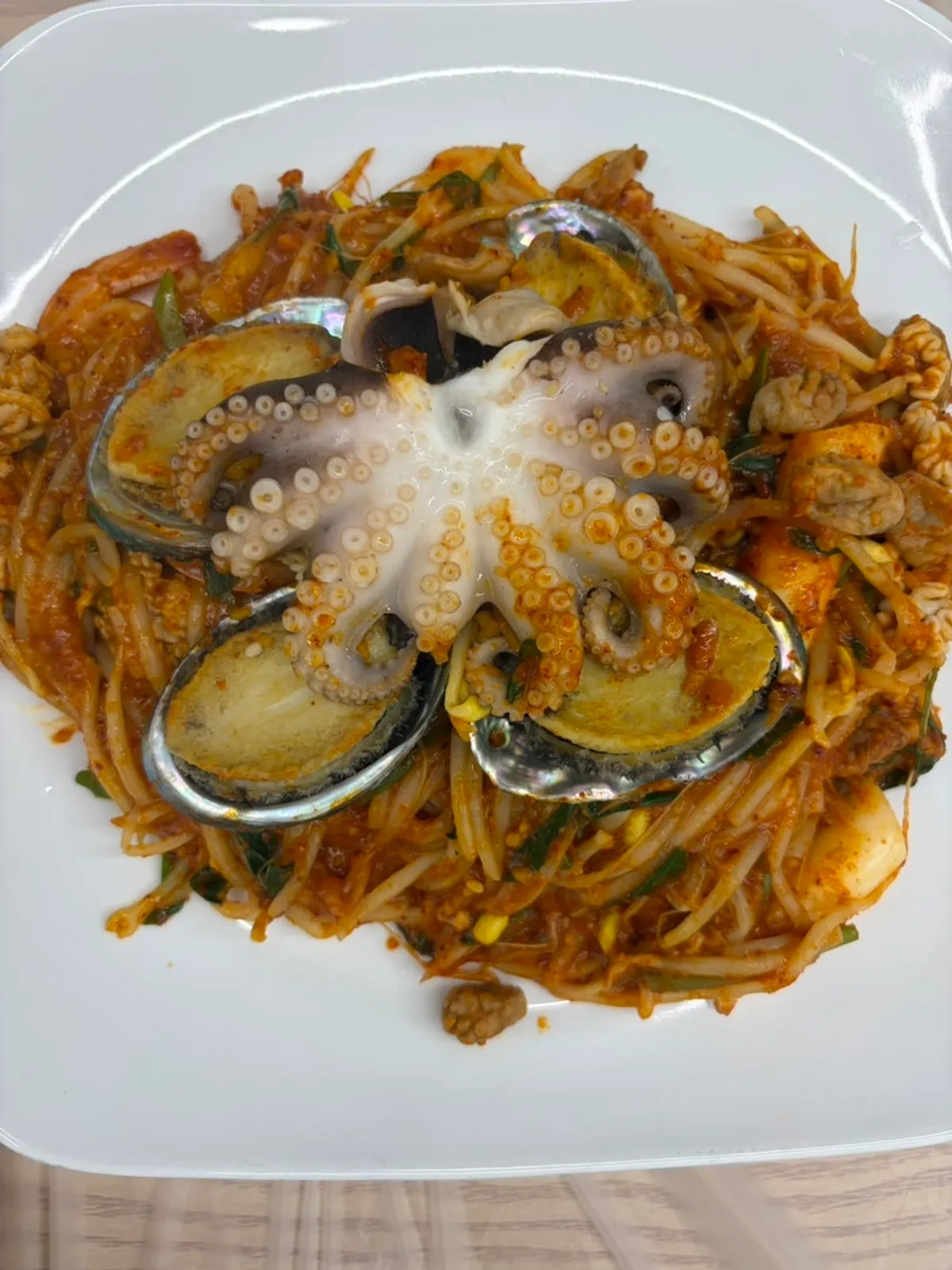 Small-size abalone seafood stew topped with four abalones
