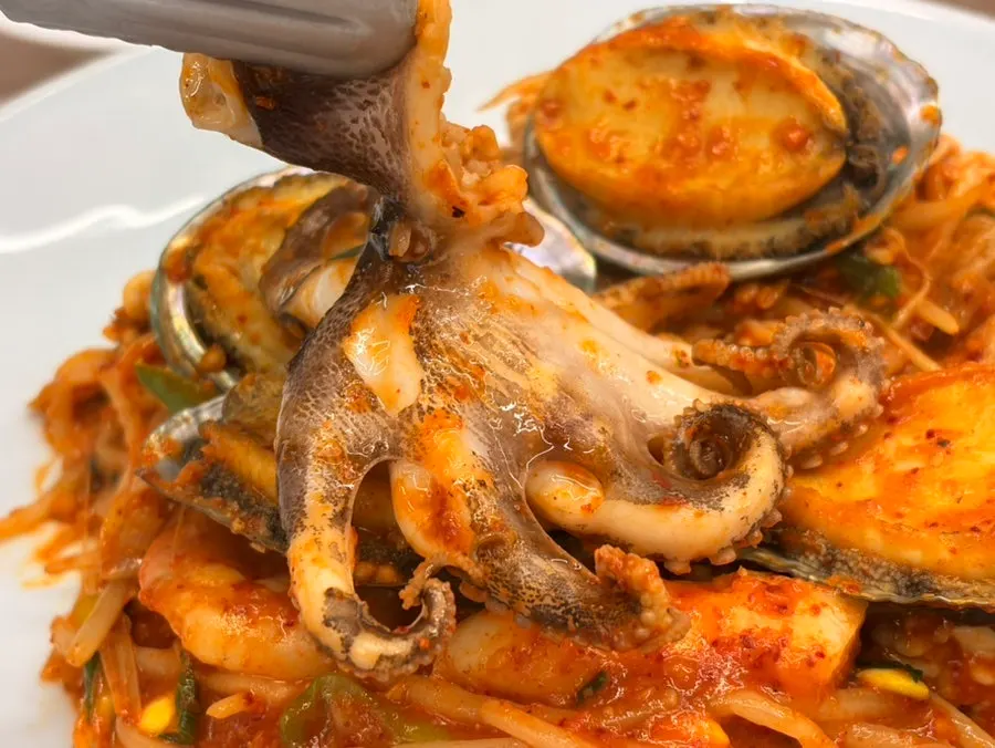 Small octopus on top of the abalone seafood stew