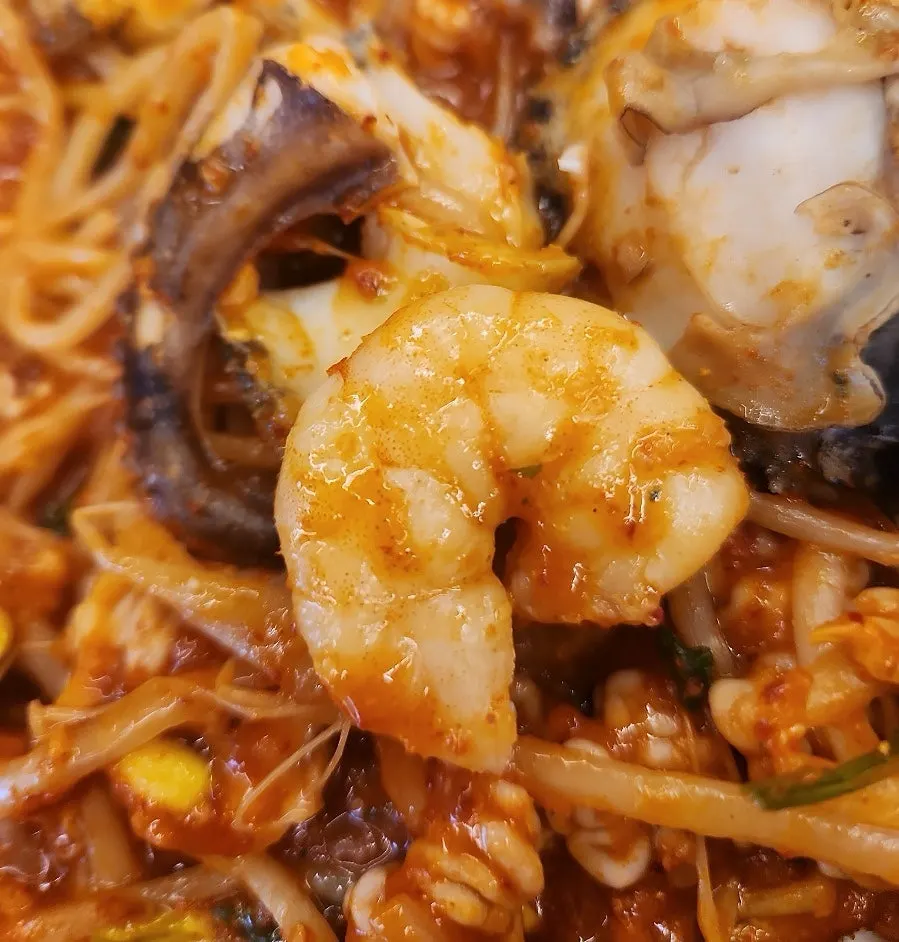 Seafood stew topped with 4 abalones, octopus, and shrimp