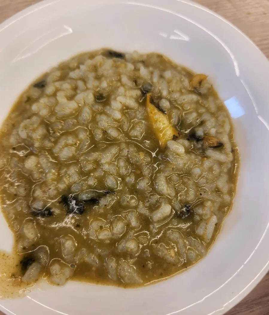 Abalone porridge topped with seaweed flakes and sesame seeds