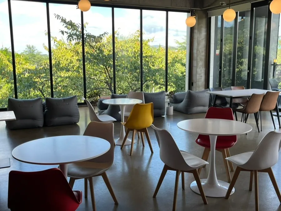Tables and floor-to-ceiling windows inside Café Yard