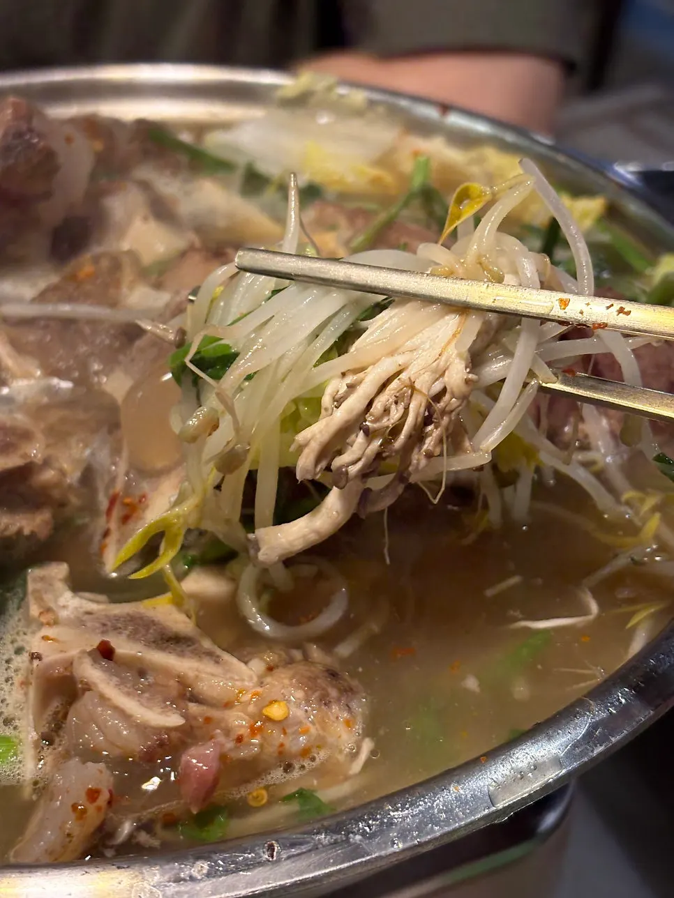 Meat pulled off the bone from the beef bone hot pot