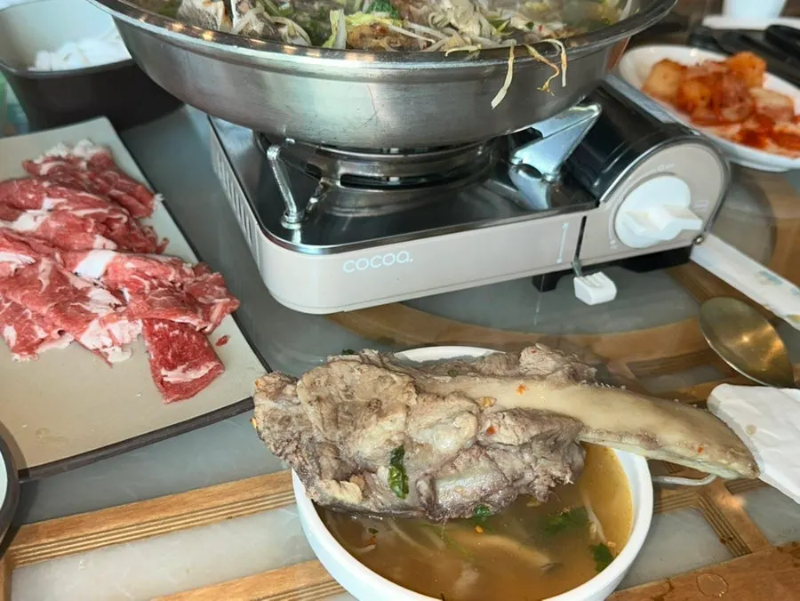 Scooping up the last of the hot pot broth
