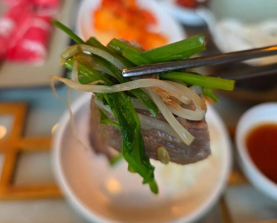 Bowl of rich beef bone broth with minari