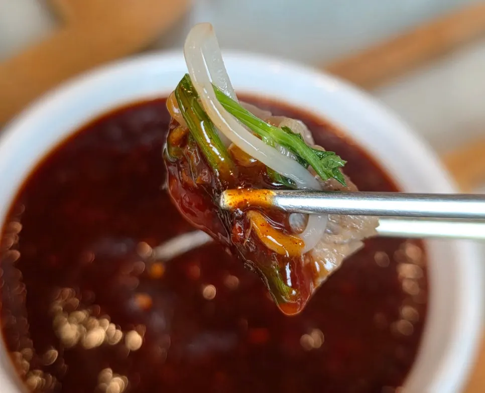 Meat dipped in the extra spicy sauce