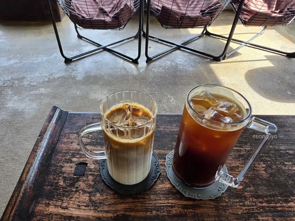Two cups of Bonghwangdang coffee on a window-side table