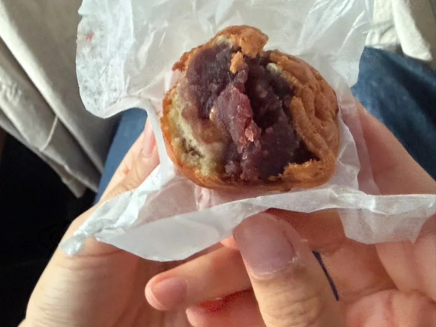Eating a walnut pastry straight from the box in the car