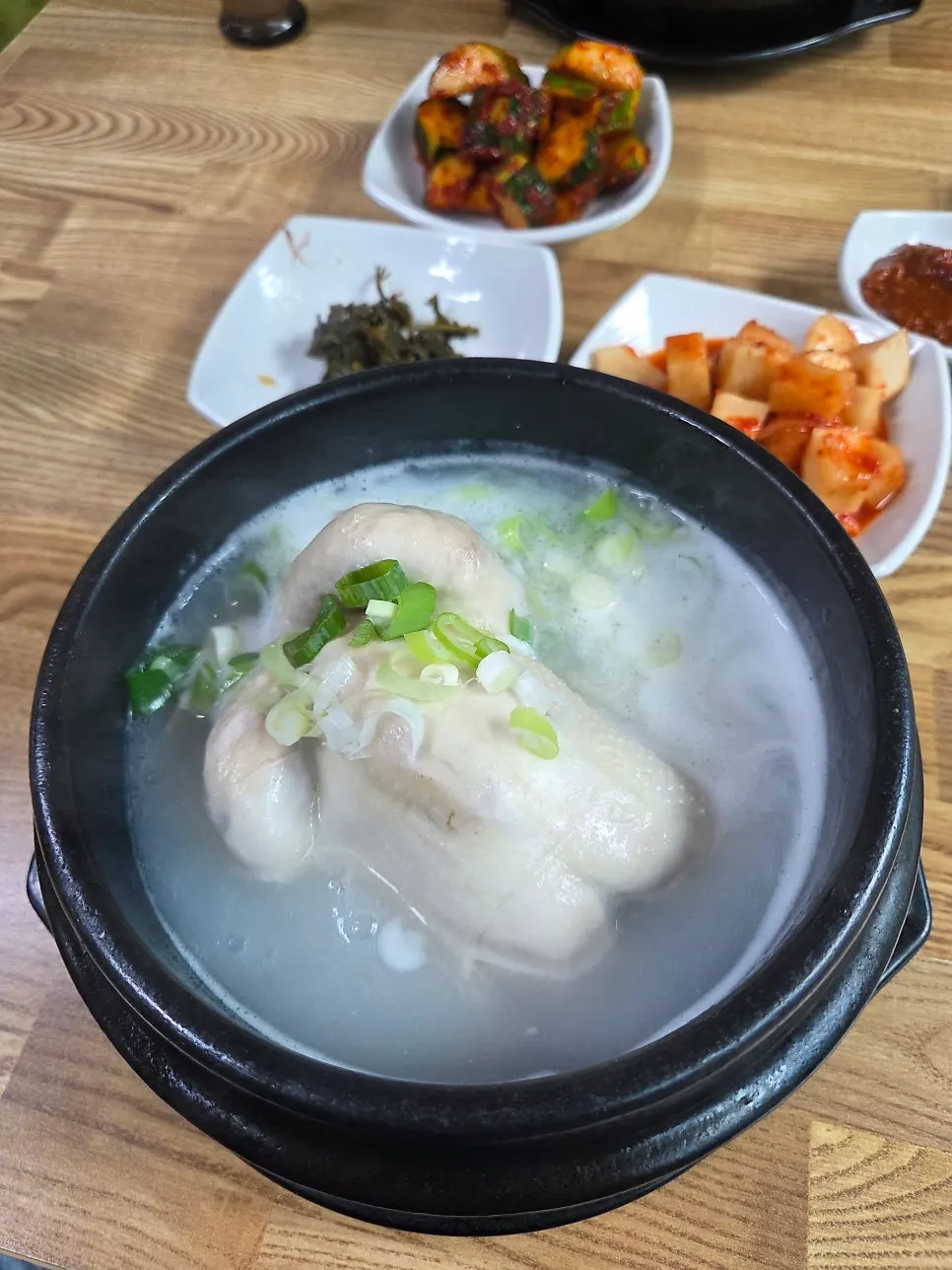 Earthenware bowl of yeongyang samgyetang with rice inside