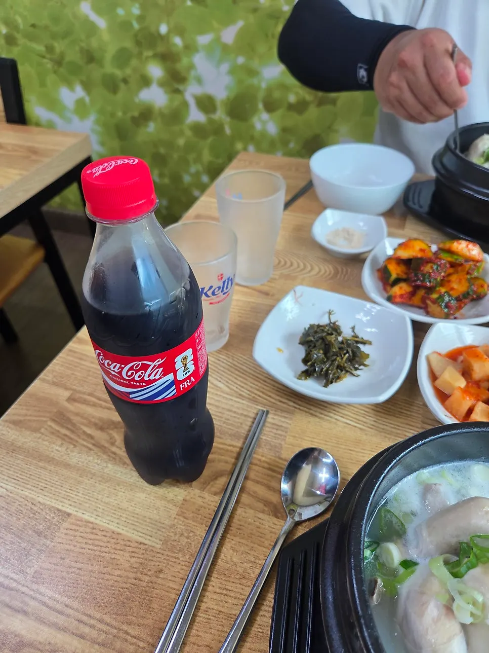 A glass of cola next to the samgyetang