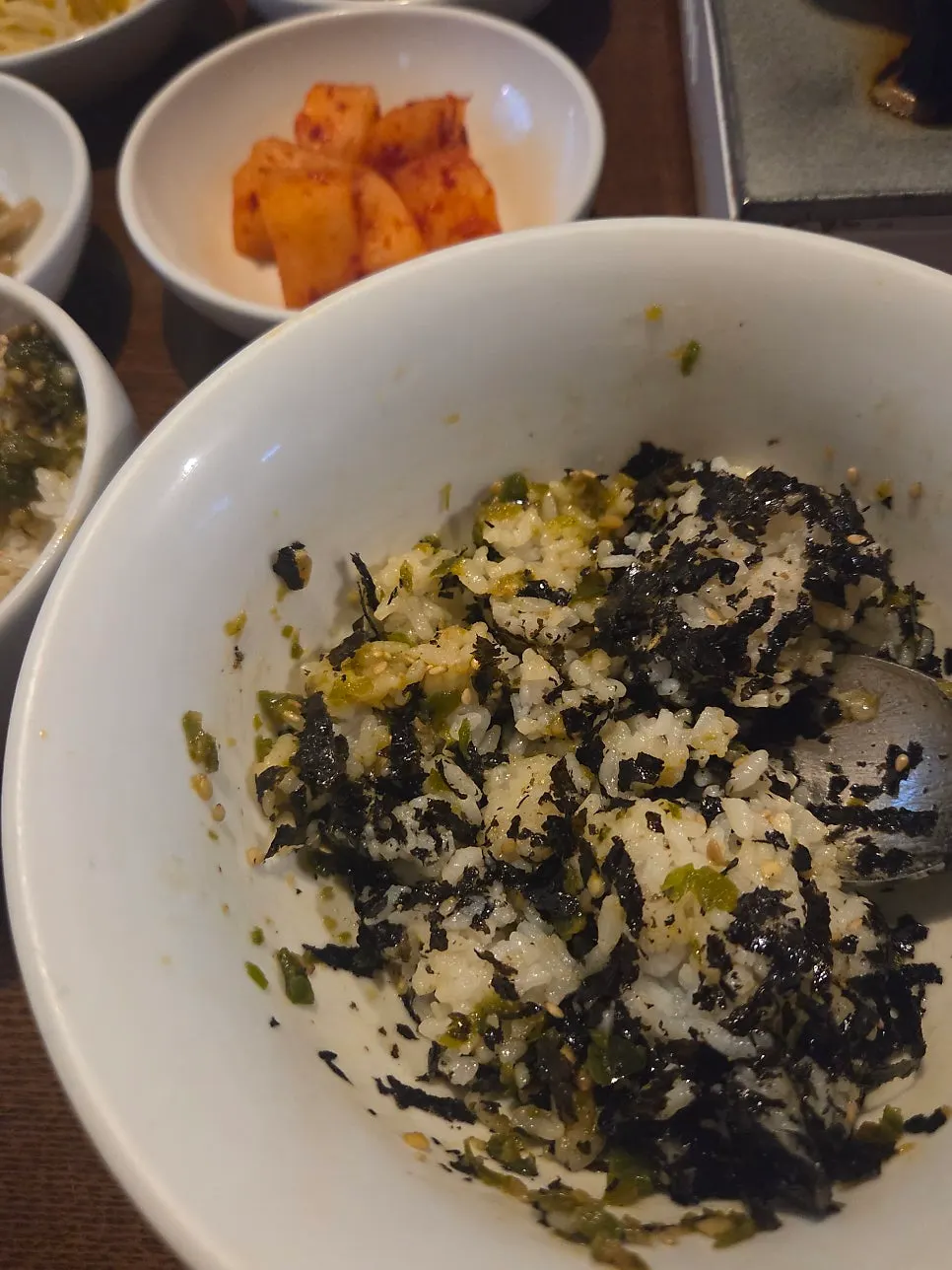 A bite of ttaengcho-bap mixed with sauce